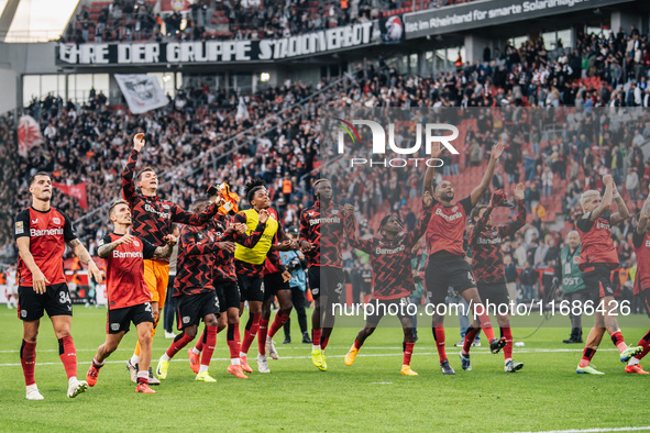 Players of Bayer 04 Leverkusen celebrate with fans after the Bundesliga match between Bayer 04 Leverkusen and Eintracht Frankfurt at BayAren...