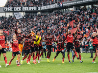 Players of Bayer 04 Leverkusen celebrate with fans after the Bundesliga match between Bayer 04 Leverkusen and Eintracht Frankfurt at BayAren...