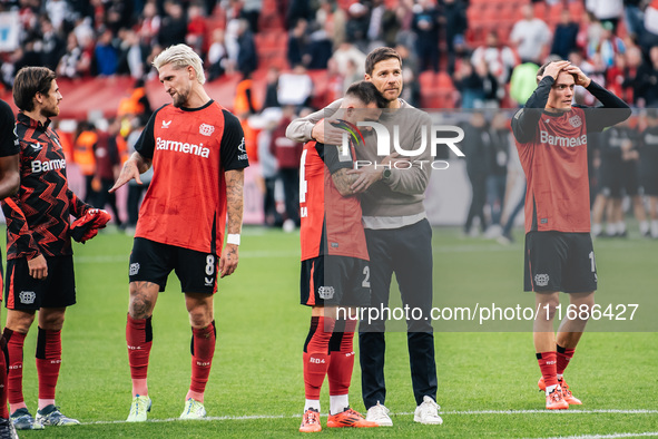 Xabi Alonso, Head Coach of Bayer 04 Leverkusen, hugs Aleix Garcia of Bayer 04 Leverkusen after the Bundesliga match between Bayer 04 Leverku...