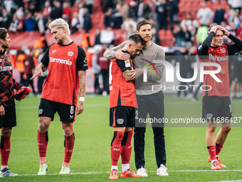 Xabi Alonso, Head Coach of Bayer 04 Leverkusen, hugs Aleix Garcia of Bayer 04 Leverkusen after the Bundesliga match between Bayer 04 Leverku...