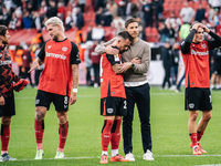 Xabi Alonso, Head Coach of Bayer 04 Leverkusen, hugs Aleix Garcia of Bayer 04 Leverkusen after the Bundesliga match between Bayer 04 Leverku...