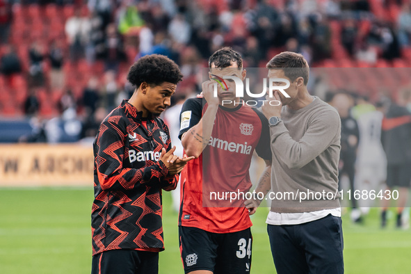 Xabi Alonso, Head Coach of Bayer 04 Leverkusen, speaks with Granit Xhaka and Amine Adli after the Bundesliga match between Bayer 04 Leverkus...