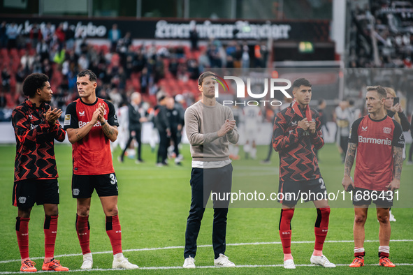 Xabi Alonso, Head Coach of Bayer 04 Leverkusen, and his players celebrate with fans after the Bundesliga match between Bayer 04 Leverkusen a...