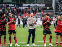 Xabi Alonso, Head Coach of Bayer 04 Leverkusen, and his players celebrate with fans after the Bundesliga match between Bayer 04 Leverkusen a...