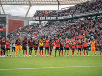 Players of Bayer 04 Leverkusen celebrate with fans after the Bundesliga match between Bayer 04 Leverkusen and Eintracht Frankfurt at BayAren...