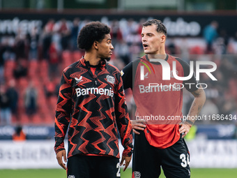 Granit Xhaka of Bayer 04 Leverkusen speaks with his teammate Amine Adli after the Bundesliga match between Bayer 04 Leverkusen and Eintracht...