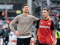 Xabi Alonso, Head Coach of Bayer 04 Leverkusen, and Alejandro Grimaldo of Bayer 04 Leverkusen celebrate with fans after the Bundesliga match...