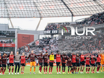 Players of Bayer 04 Leverkusen celebrate with fans after the Bundesliga match between Bayer 04 Leverkusen and Eintracht Frankfurt at BayAren...