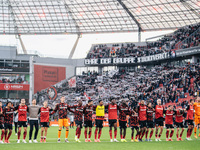 Players of Bayer 04 Leverkusen celebrate with fans after the Bundesliga match between Bayer 04 Leverkusen and Eintracht Frankfurt at BayAren...