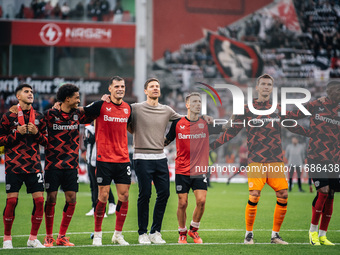 Xabi Alonso, Head Coach of Bayer 04 Leverkusen, and his players celebrate with fans after the Bundesliga match between Bayer 04 Leverkusen a...