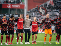 Xabi Alonso, Head Coach of Bayer 04 Leverkusen, and his players celebrate with fans after the Bundesliga match between Bayer 04 Leverkusen a...