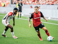 Alejandro Grimaldo of Bayer 04 Leverkusen plays against Junior Dina Ebimbe of Eintracht Frankfurt during the Bundesliga match between Bayer...