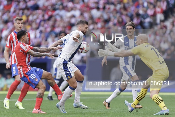 Matija Nastasic of Leganes and Angel Correa of Atletico de Madrid fight for the ball during the La Liga 2024/25 match between Atletico de Ma...