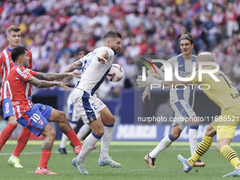 Matija Nastasic of Leganes and Angel Correa of Atletico de Madrid fight for the ball during the La Liga 2024/25 match between Atletico de Ma...