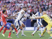 Matija Nastasic of Leganes and Angel Correa of Atletico de Madrid fight for the ball during the La Liga 2024/25 match between Atletico de Ma...