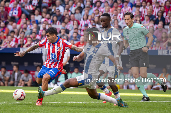 Angel Correa of Atletico de Madrid (L) is in action against Renato Tapia of CD Leganes (R) during the La Liga EA Sports 2024/25 football mat...