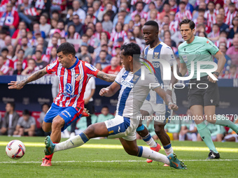 Angel Correa of Atletico de Madrid (L) is in action against Renato Tapia of CD Leganes (R) during the La Liga EA Sports 2024/25 football mat...