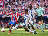 Angel Correa of Atletico de Madrid (L) is in action against Renato Tapia of CD Leganes (R) during the La Liga EA Sports 2024/25 football mat...