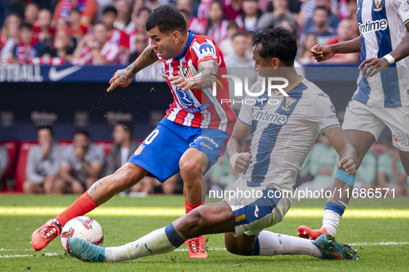 Angel Correa of Atletico de Madrid (L) is in action against Renato Tapia of CD Leganes (R) during the La Liga EA Sports 2024/25 football mat...