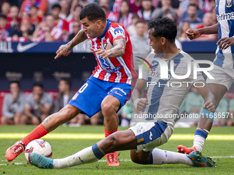 Angel Correa of Atletico de Madrid (L) is in action against Renato Tapia of CD Leganes (R) during the La Liga EA Sports 2024/25 football mat...