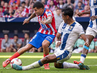 Angel Correa of Atletico de Madrid (L) is in action against Renato Tapia of CD Leganes (R) during the La Liga EA Sports 2024/25 football mat...