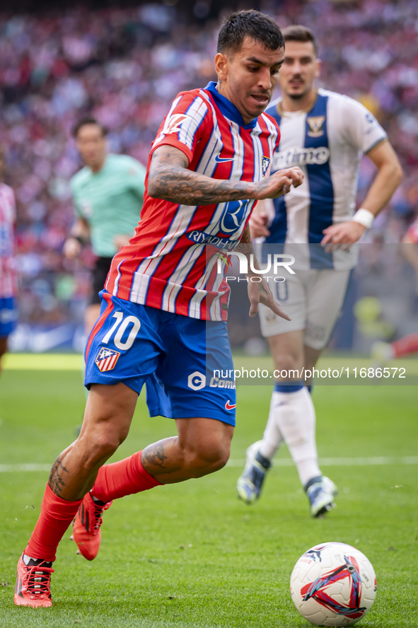 Angel Correa of Atletico de Madrid is in action with the ball during the La Liga EA Sports 2024/25 football match between Atletico de Madrid...