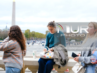 A One Direction fan writes a note for the makeshift memorial to Liam Payne in the Tuileries Gardens in Paris, France. (