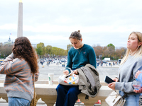 A One Direction fan writes a note for the makeshift memorial to Liam Payne in the Tuileries Gardens in Paris, France. (