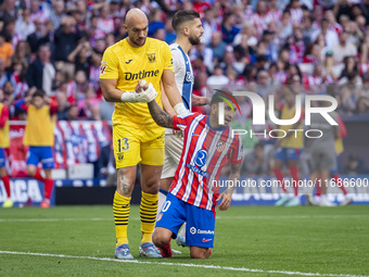 Marko Dmitrovic of CD Leganes (L) helps Angel Correa of Atletico de Madrid (R) during the La Liga EA Sports 2024/25 football match between A...