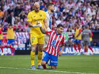 Marko Dmitrovic of CD Leganes (L) helps Angel Correa of Atletico de Madrid (R) during the La Liga EA Sports 2024/25 football match between A...