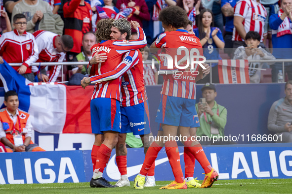 Antoine Griezmann of Atletico de Madrid (L) celebrates his goal with Rodrigo De Paul and Axel Witsel during the La Liga EA Sports 2024/25 fo...