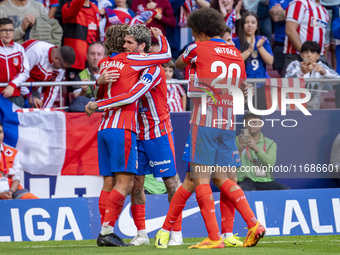 Antoine Griezmann of Atletico de Madrid (L) celebrates his goal with Rodrigo De Paul and Axel Witsel during the La Liga EA Sports 2024/25 fo...