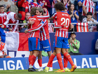 Antoine Griezmann of Atletico de Madrid (L) celebrates his goal with Rodrigo De Paul and Axel Witsel during the La Liga EA Sports 2024/25 fo...