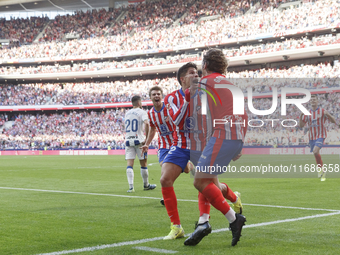 In Madrid, Spain, on October 20, Antoine Griezmann of Atletico de Madrid and Giuliano Simeone of Atletico de Madrid celebrate a goal during...