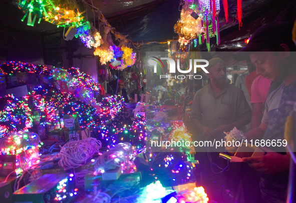 Vendors sell decorative lights before the Diwali festival inside an electronics market in Kolkata, India, on October 20, 2024. 