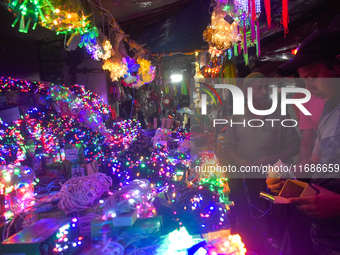 Vendors sell decorative lights before the Diwali festival inside an electronics market in Kolkata, India, on October 20, 2024. (