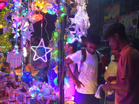 People buy decorative lights before the Diwali festival inside an electronics market in Kolkata, India, on October 20, 2024. (