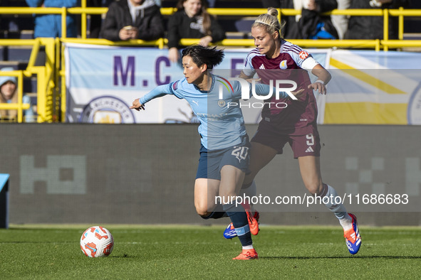 Aoba Fujino #20 of Manchester City W.F.C. is challenged by Rachel Daly #9 of Aston Villa W.F.C during the Barclays FA Women's Super League m...