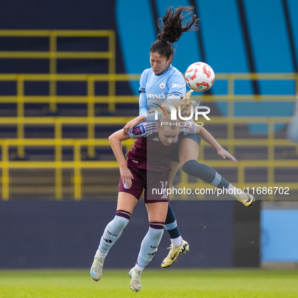 Katie Robinson #11 of Aston Villa W.F.C. engages in an aerial challenge with Leila Ouahabi #15 of Manchester City W.F.C. during the Barclays...