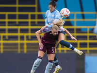 Katie Robinson #11 of Aston Villa W.F.C. engages in an aerial challenge with Leila Ouahabi #15 of Manchester City W.F.C. during the Barclays...