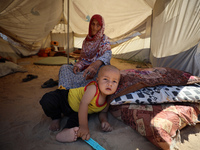 Displaced Palestinians are seen in a temporary camp in Khan Yunis, Gaza Strip, on October 20, 2024, amid the ongoing war in the Palestinian...