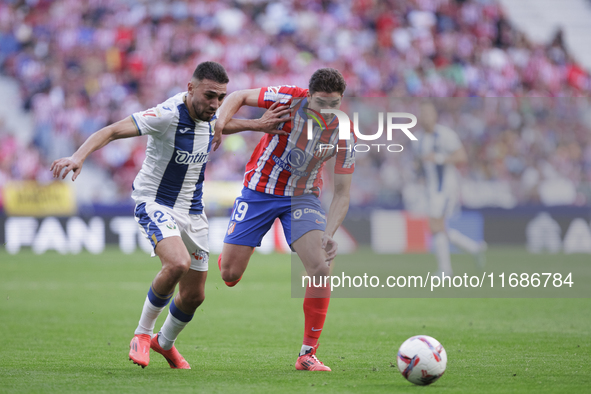 Julian Alvarez of Atletico de Madrid and Munir El Haddadi of Leganes fight for the ball during the La Liga 2024/25 match between Atletico de...