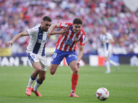 Julian Alvarez of Atletico de Madrid and Munir El Haddadi of Leganes fight for the ball during the La Liga 2024/25 match between Atletico de...