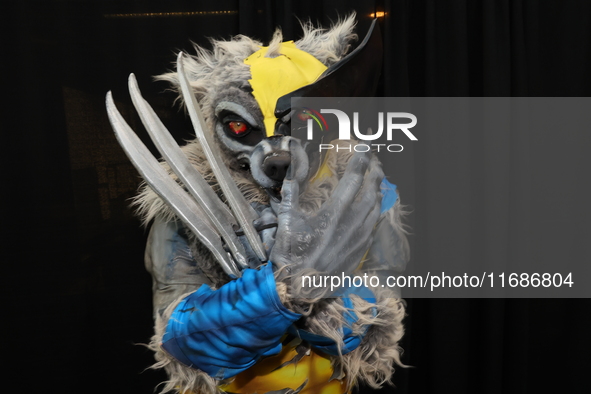 A cosplayer dressed as a werewolf and Wolverine combo poses for a photo during New York Comic Con at the Javits Center in New York City, on...