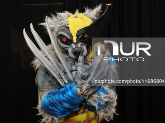 A cosplayer dressed as a werewolf and Wolverine combo poses for a photo during New York Comic Con at the Javits Center in New York City, on...