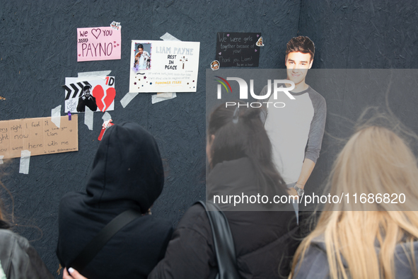 A hundred fans of former One Direction member Liam Payne gather to hold a memorial tribute at Dom Square following the death of the singer i...