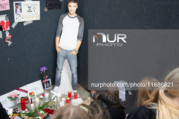 A hundred fans of former One Direction member Liam Payne gather to hold a memorial tribute at Dom Square following the death of the singer i...