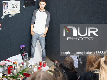 A hundred fans of former One Direction member Liam Payne gather to hold a memorial tribute at Dom Square following the death of the singer i...