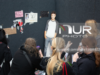 A hundred fans of former One Direction member Liam Payne gather to hold a memorial tribute at Dom Square following the death of the singer i...