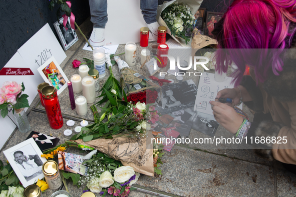 A hundred fans of former One Direction member Liam Payne gather to hold a memorial tribute at Dom Square following the death of the singer i...